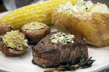 Seared filet mignon steak plated with classic sides