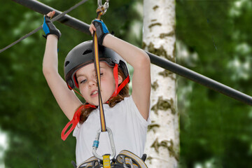 adventure climbing high wire park - people on course in mountain helmet