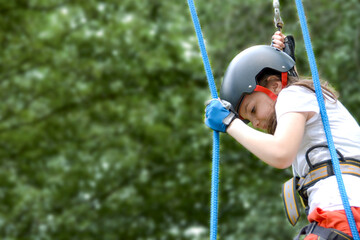 adventure climbing high wire park - people on course in mountain helmet