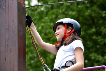 adventure climbing high wire park - people on course in mountain helmet
