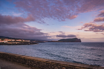 Landscape with colorful and dramatic sky at evening and Monte Brasil in horizon at sea, Terceira - Azores PORTUGAL