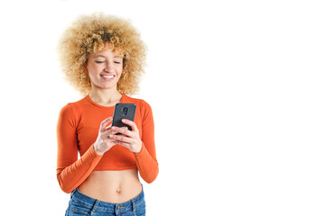 young brazilian girl with blonde afro hair smiling using her smart phone on white background - obrazy, fototapety, plakaty