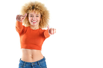 young brazilian girl with blonde afro hair smiling pointing at camera on white background