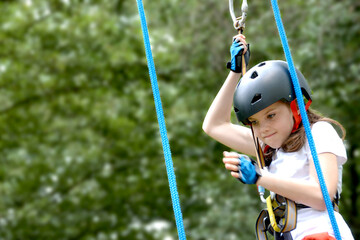 adventure climbing high wire park - people on course in mountain helmet