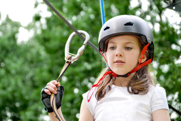 Fototapeta na wymiar adventure climbing high wire park - people on course in mountain helmet