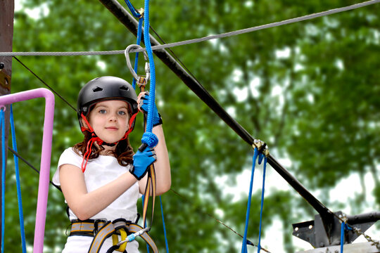 adventure climbing high wire park - people on course in mountain helmet
