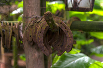 Closeup shot of vintage horseshoes hanging on a metal rod