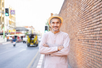 senior man tourist standing outdoors in the city, older adult travel in southeast asia,destination...