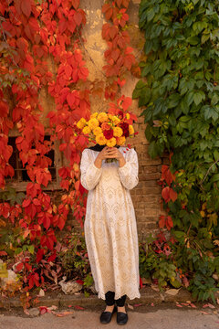 woman holding autumn bouquet of flowers 