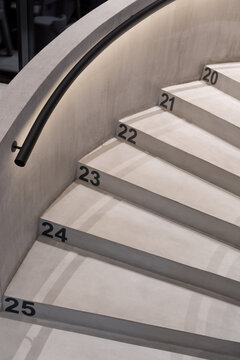 Hall with textured concrete staircase with backlight