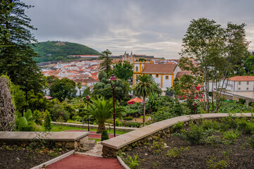 Trees in the Duque da Terceira garden with view of the architecture of Angra do Heroísmo and Monte Brasil in the background, Terceira - Azores PORTUGAL