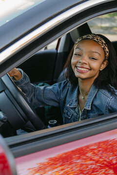 happy  smiling young woman in her car