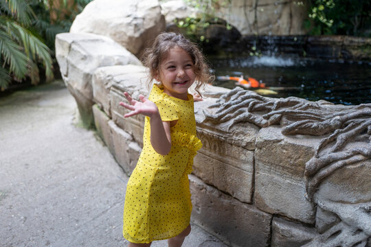  ugc image of girl waving and smiling at the zoo