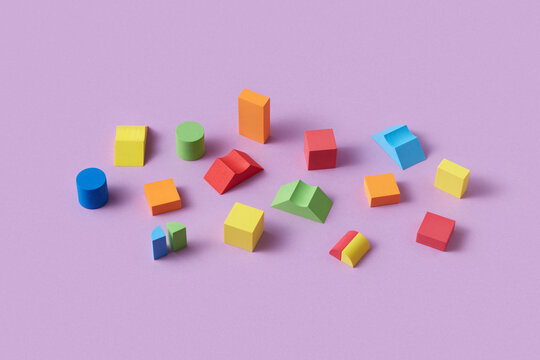 Different colorful wooden blocks scattered on purple background
