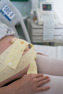 A woman monitoring uterine contractions during pregnancy