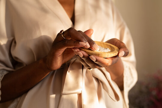 Woman using skincare product at home