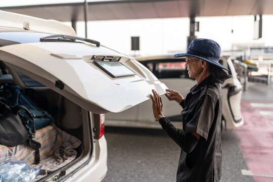 Man opening the trunk of the car.