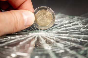 European money, 2 euro coin reflecting in broken glass, Financial concept, European currency, Rate drop, analysis and forecasts for the euro zone, close up - 777648939