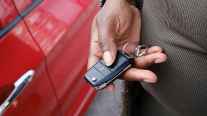 Crop of hand opening car with remote key