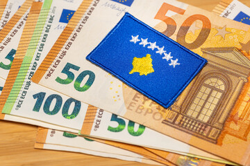 The flag of Kosovo against the background of the common currency of the European Union, the concept of Kosovo's accession to the euro zone - 777648985