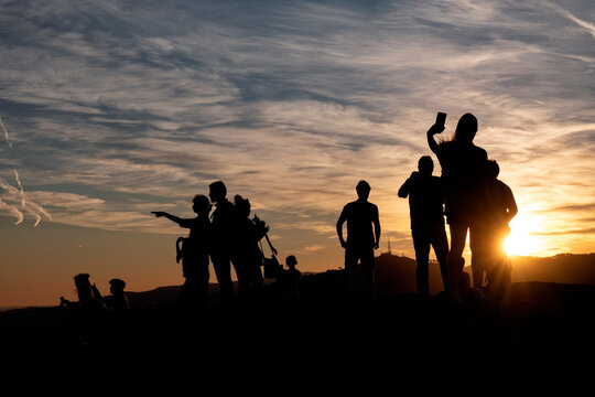 Silhouette Of A Group Of People At Sunset