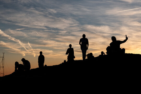 Silhouette Of A Group Of People At Sunset