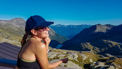 Happy woman with panoramic view of majestic mountain peaks of High Tauern, Carinthia Salzburg,...