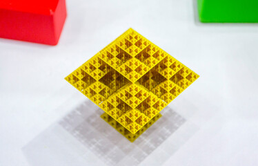 Abstract yellow object printed on 3D printer. Abstract geometric shaped object created by 3D printer. Detailed prototype printed on 3D printer close-up. New modern additive 3D printing technologies