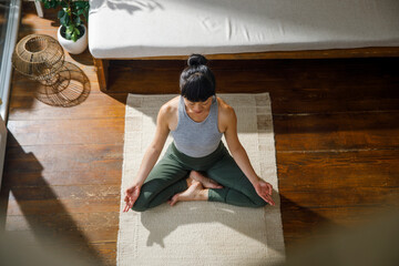HIgh angle view of woman meditating at home