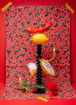 A bright conceptual still life with a candlestick and fabric.