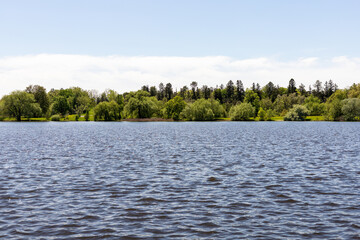 Panoramic view of lake surrounded by forest. Natural landscape.