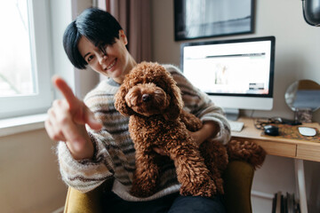 Happy female hugging cute pet dog.