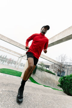 Low angle shot of a young black man practicing aerobic exercise