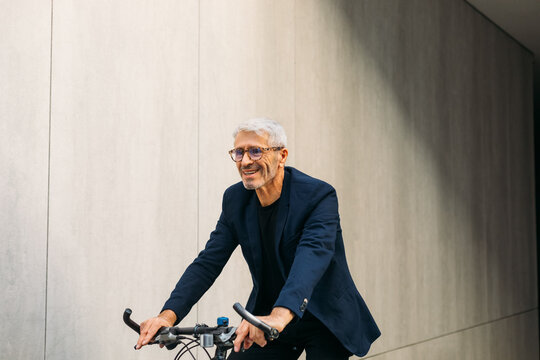 Senior man riding bike - Powered by Adobe