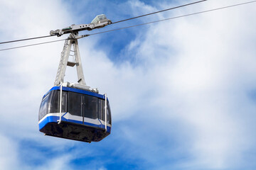 Moving cablecar against blue sky