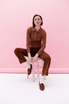 Relaxed woman studio portrait pink background