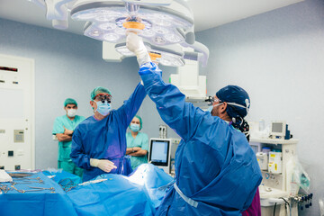 Medical team performing surgery in modern operating room