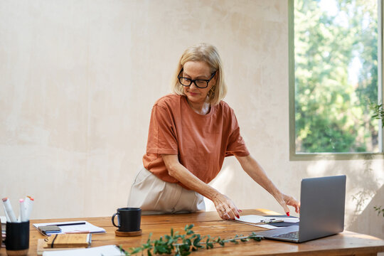 mature woman organising her desk 