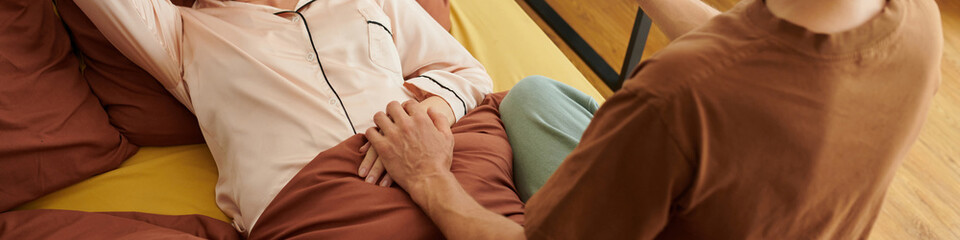 Web banner with husband touching hand of his sick wife - obrazy, fototapety, plakaty