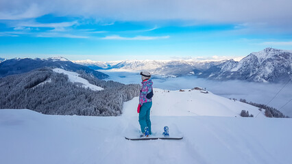 Snowboard woman on powder snow in ski resort Dreilaendereck in Karawanks, Carinthia, Austria....