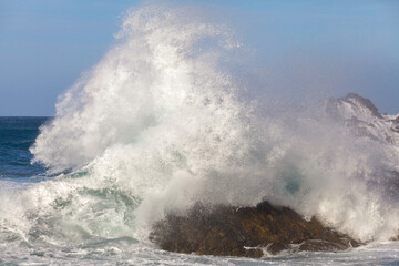 Ocean waves crushing against rocks