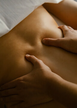 woman giving back massage to a girl

