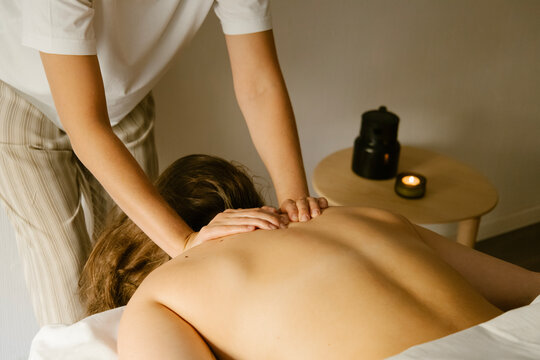woman giving back massage to a girl

