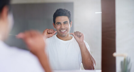 Happy, mirror and man with floss in bathroom for dental hygiene, gum disease and oral care. Health,...