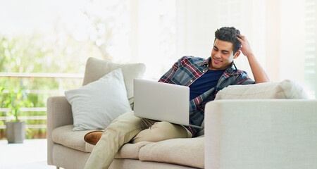Man, laptop and sofa for internet search in home for streaming entertainment, subscription or...