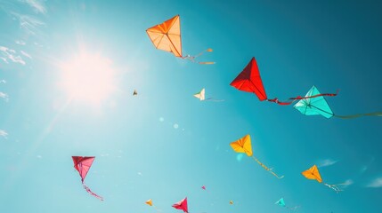 A kite flying against a clear blue sky, is a popular Sinhalese New Year activity. The kites are brightly colored, reflecting the joy and freedom associated with the celebration of new beginnings - obrazy, fototapety, plakaty