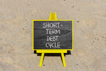 Short-term debt cycle symbol. Concept words Short-term debt cycle on beautiful black chalk blackboard. Beautiful sand beach background. Business Short-term debt cycle concept. Copy space