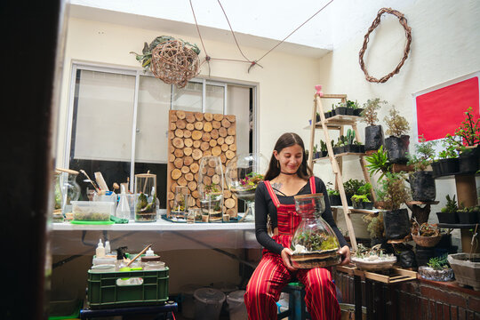 Woman holding a terrarium