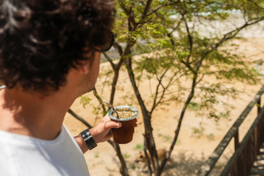 Man holding a yerba mate tea cup