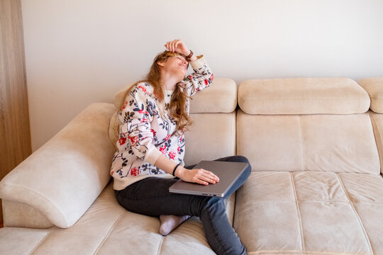Woman sitting with closed laptop after work